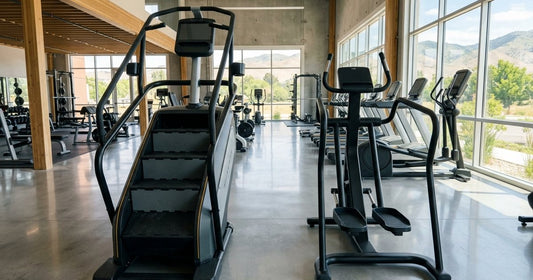 Commercial stepmill and pedal stair climber side by side in a bright Boise fitness equipment showroom