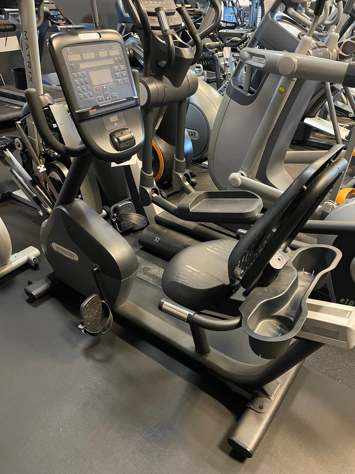 Like-new Precor RBK 635 recumbent bike with step-through frame among other cardio machines